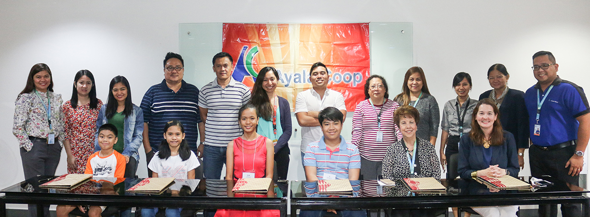 The four new APEC scholars (seated, from left) – Lance Amon, Monic Celis, Sam Calamiong and J.C. Buenaventura – are shown with their parents as well as Ayala Coop, APEC and Ayala Foundation officials during the signing ceremony.